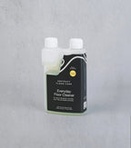 Bottle of Everyday Floor Cleaner by Abstract Floor Care on a gray background