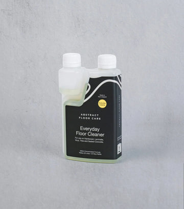 Bottle of Everyday Floor Cleaner by Abstract Floor Care on a gray background