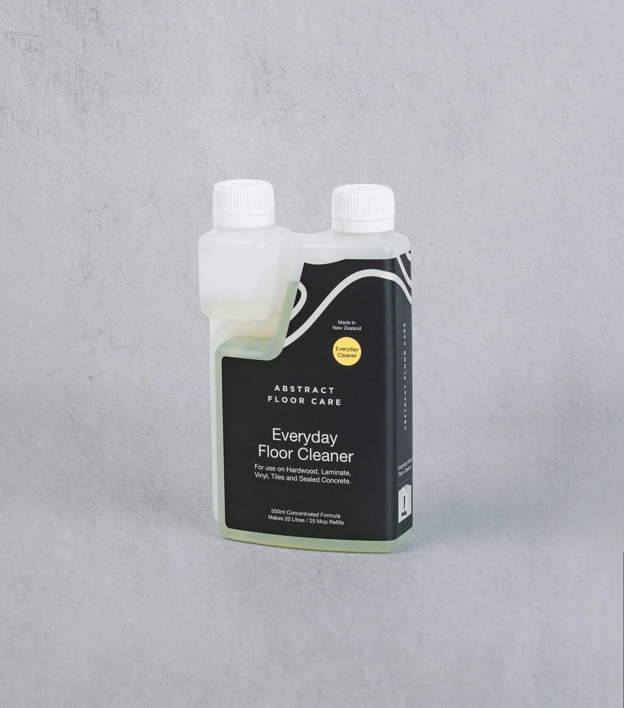 Bottle of Everyday Floor Cleaner by Abstract Floor Care on a gray background