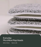 Stack of microfiber mop heads with a neutral background
